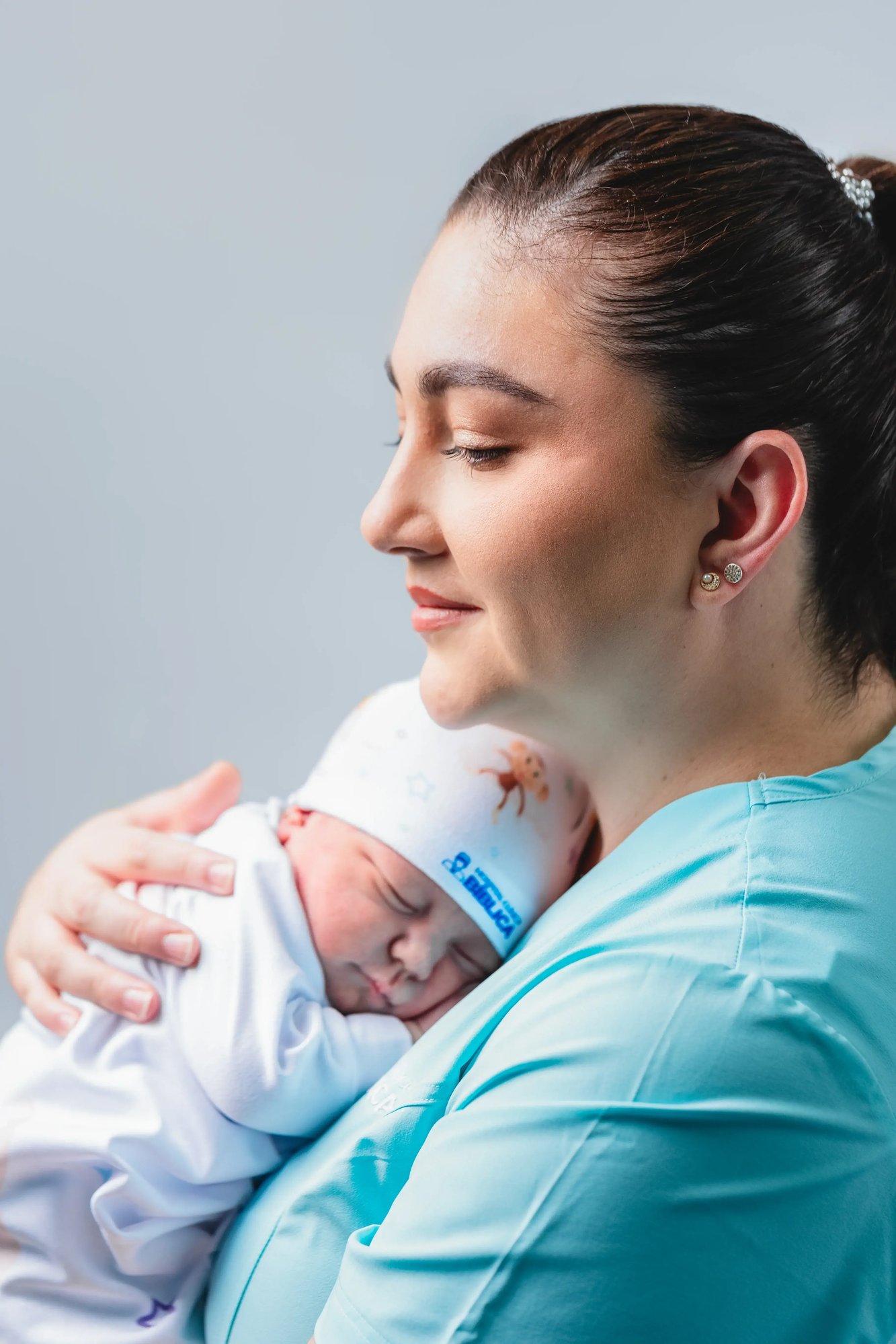 Nurse holding a newborn in her arms
