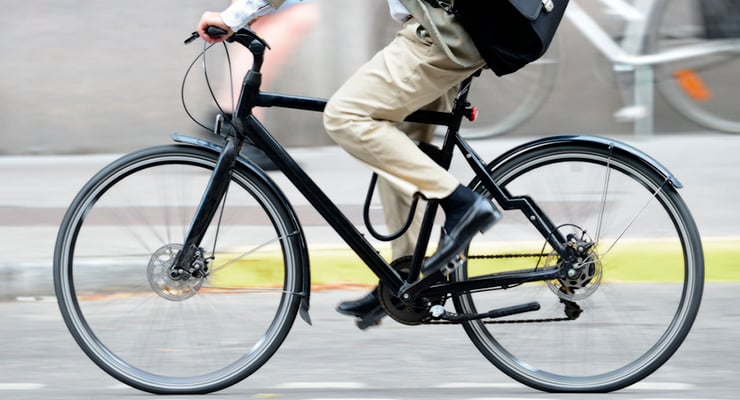 Persona desplazándose en bicicleta urbana por la ciudad