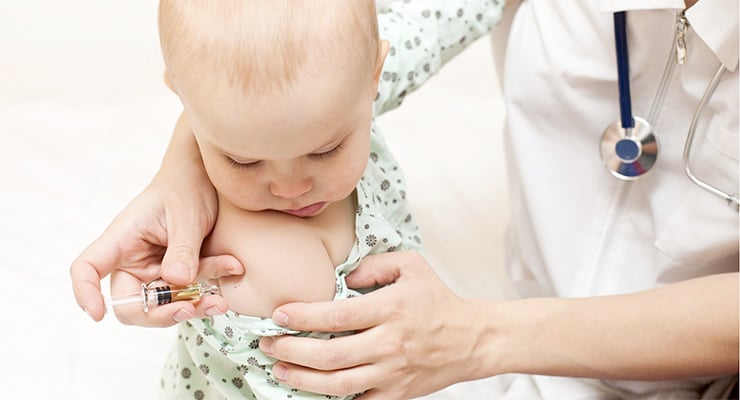 Personal de salud aplicando una vacuna a un bebé en el brazo