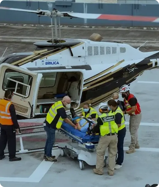 Equipo médico trasladando a un paciente desde un helicóptero en el helipuerto. Equipo médico trasladando a un paciente desde un helicóptero en el helipuerto.